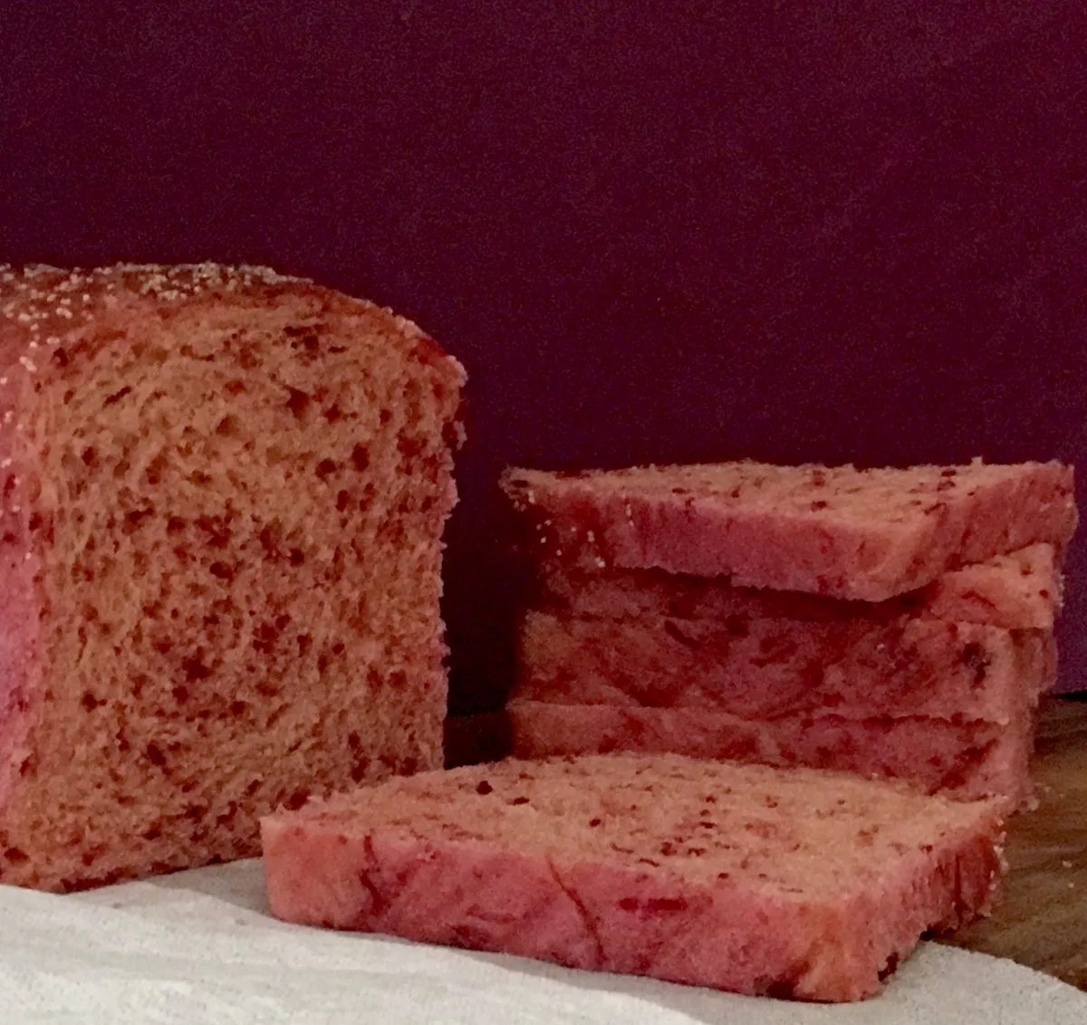 Beetroot bread topped with poppy seeds..